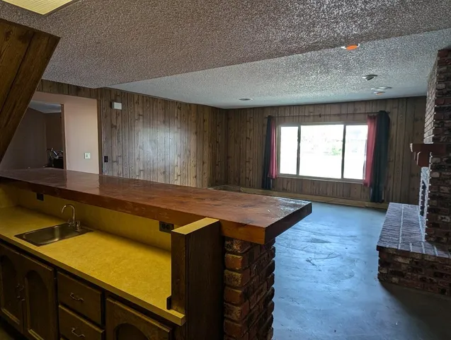 a kitchen with kitchen island a sink table and chairs