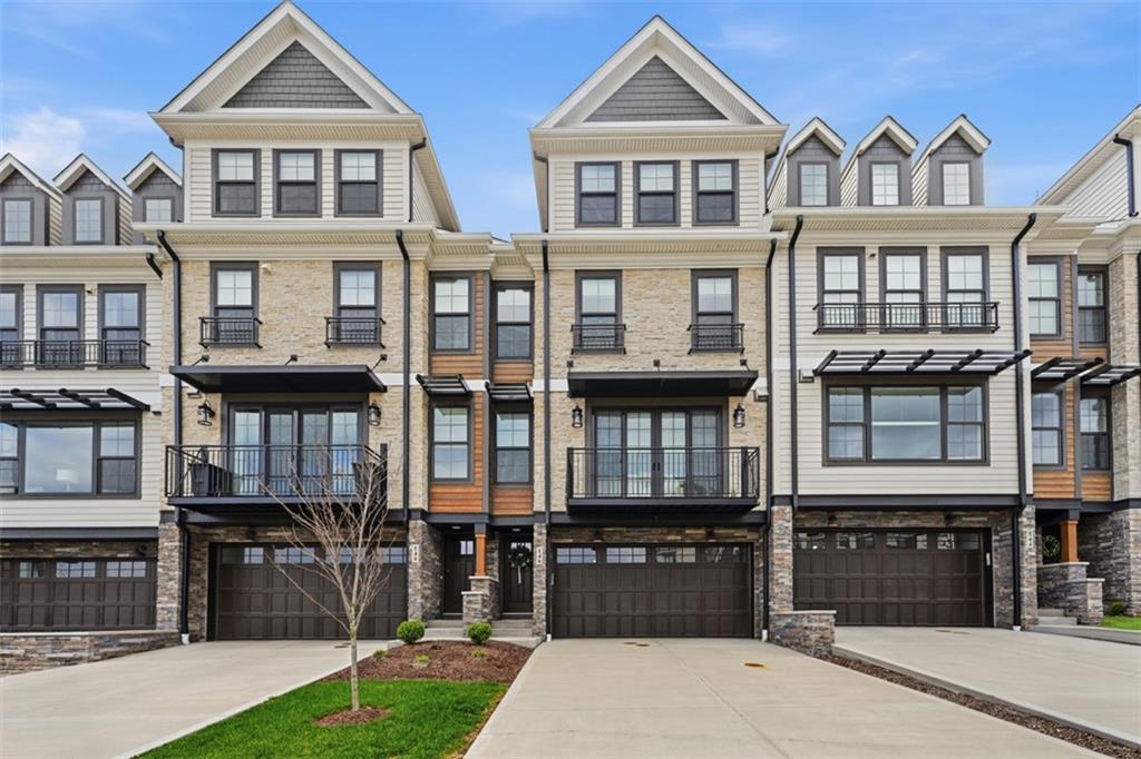 a front view of a residential apartment building with a yard