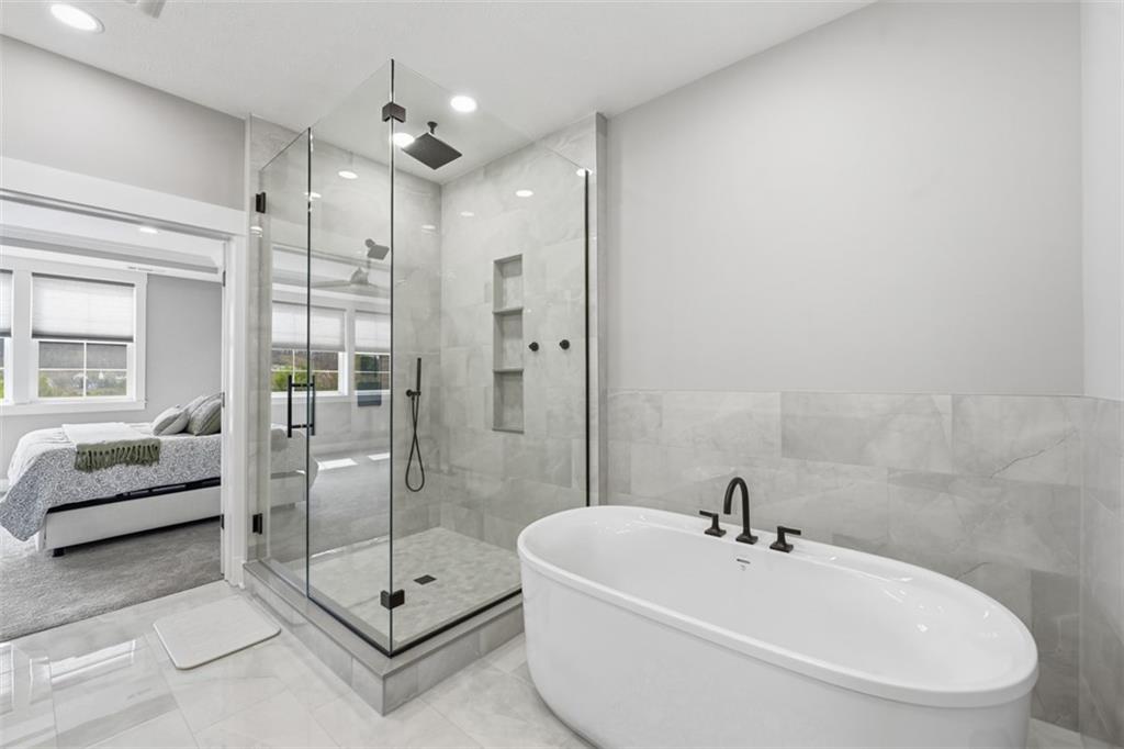 146 Enclave Drive Mars, PA 16046 - Photo 15 of 48 a bathroom with a tub a mirror and shower
