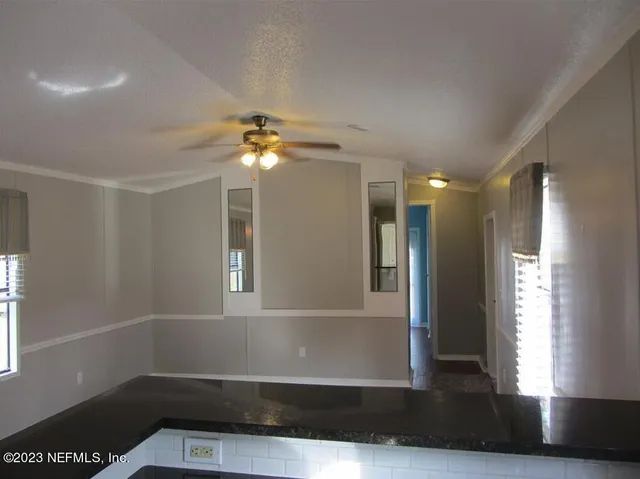 a view of livingroom with chandelier and hardwood floor