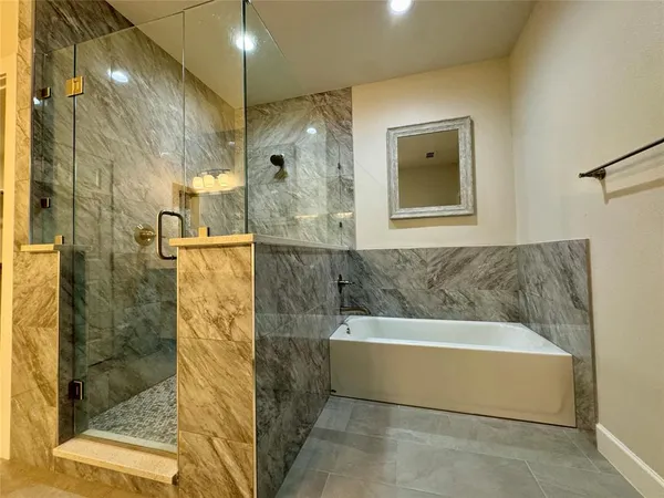 a bathroom with a bathtub and shower