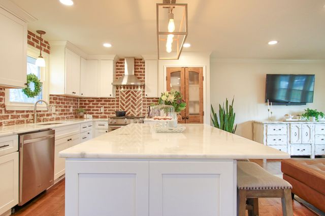 a view of a couches in a patio with a yard