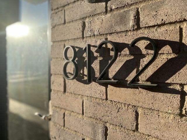 a kitchen with stainless steel appliances granite countertop a refrigerator a sink and a stove with wooden floor