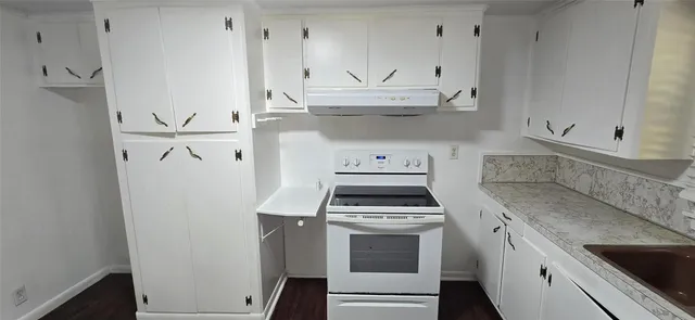 a kitchen with stainless steel appliances white cabinets and a sink