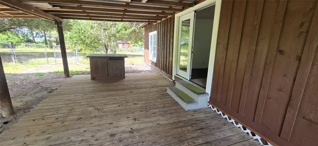 a view of a porch with wooden floor and outer view