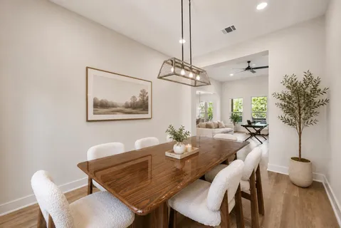a view of a dining room with furniture wooden floor and chandelier