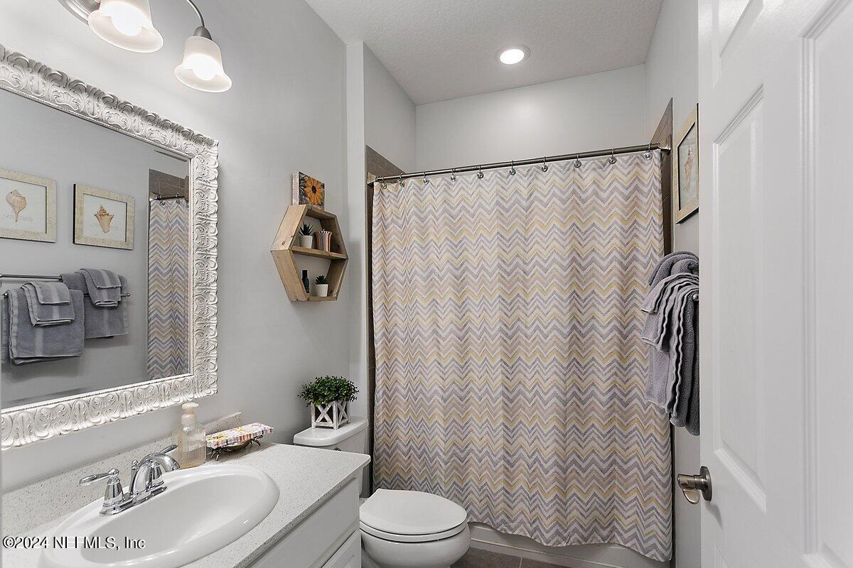 14720 Trellis Street Jacksonville, FL 32258 - Photo 11 of 21 a bathroom with a sink toilet and shower