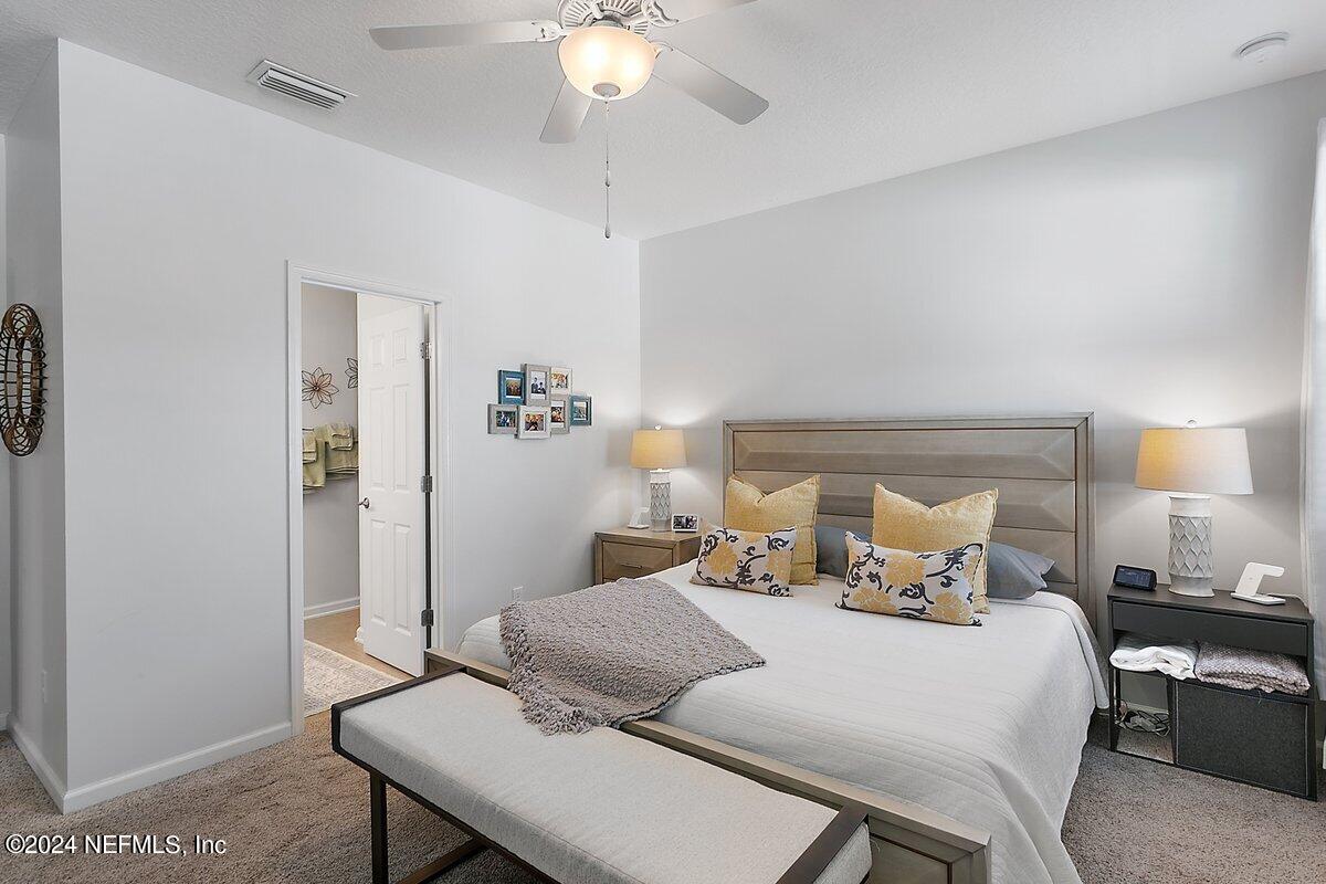 14720 Trellis Street Jacksonville, FL 32258 - Photo 14 of 21 a bedroom with a bed and a table
