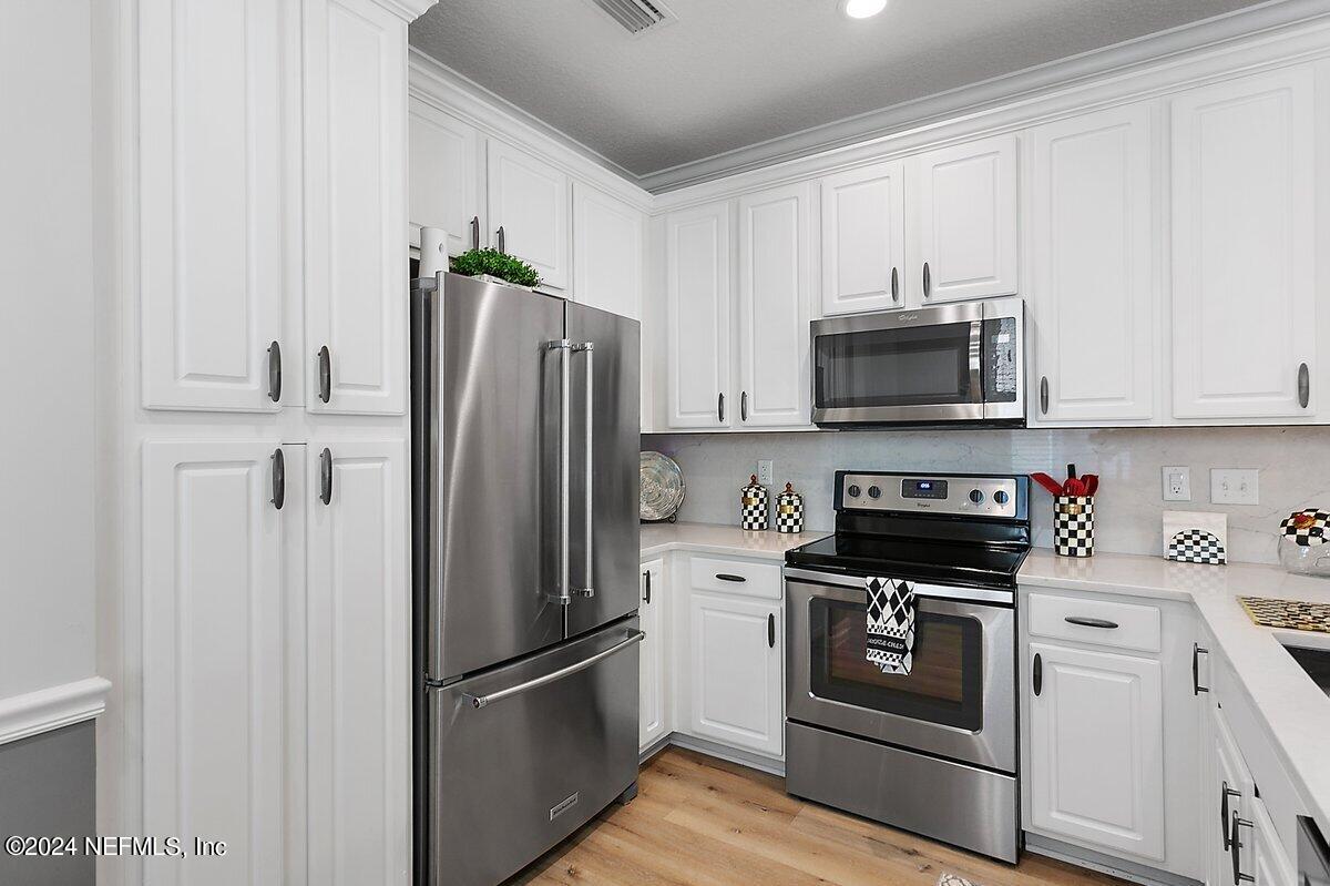 14720 Trellis Street Jacksonville, FL 32258 - Photo 5 of 21 a kitchen with stainless steel appliances a refrigerator stove and microwave