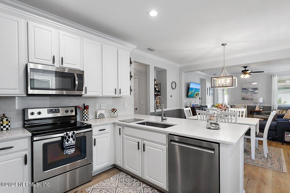 14720 Trellis Street Jacksonville, FL 32258 - Photo 6 of 21 a kitchen with a sink stove and microwave