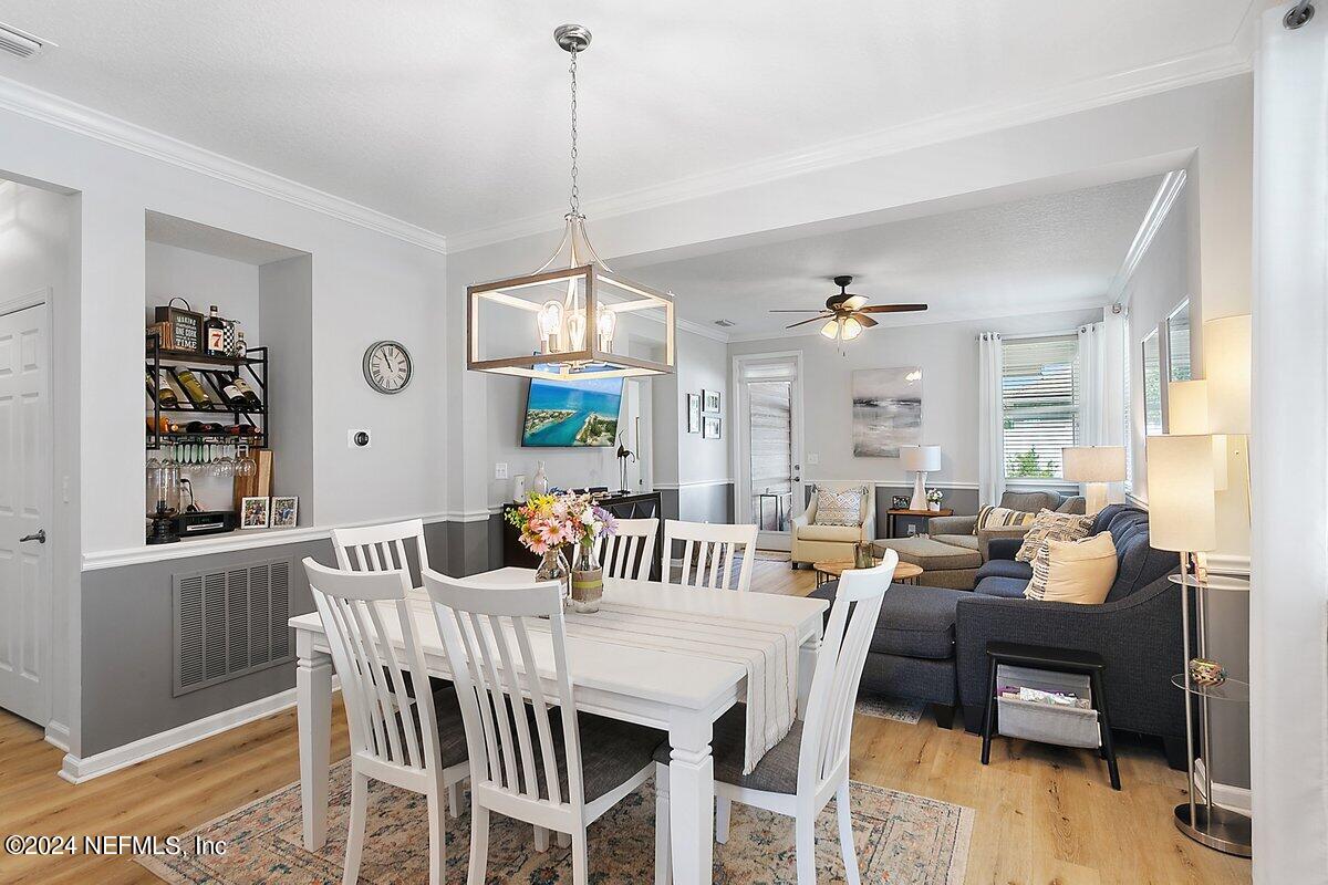 14720 Trellis Street Jacksonville, FL 32258 - Photo 7 of 21 a view of a dining room with furniture window and wooden floor
