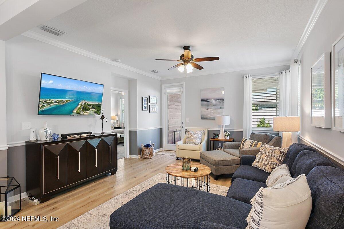 14720 Trellis Street Jacksonville, FL 32258 - Photo 9 of 21 a living room with furniture kitchen view and a flat screen tv