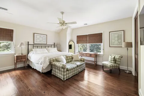 a bedroom with a bed couch and a window