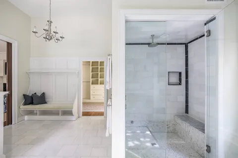 a view of a bathroom with a tub and shower