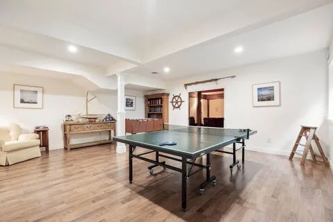 a living room with furniture wooden floor and a table