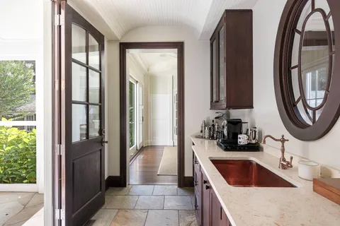 a kitchen with granite countertop a sink and a refrigerator