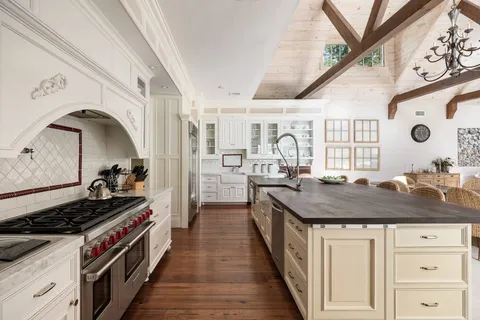 a kitchen with stainless steel appliances granite countertop a stove and cabinets