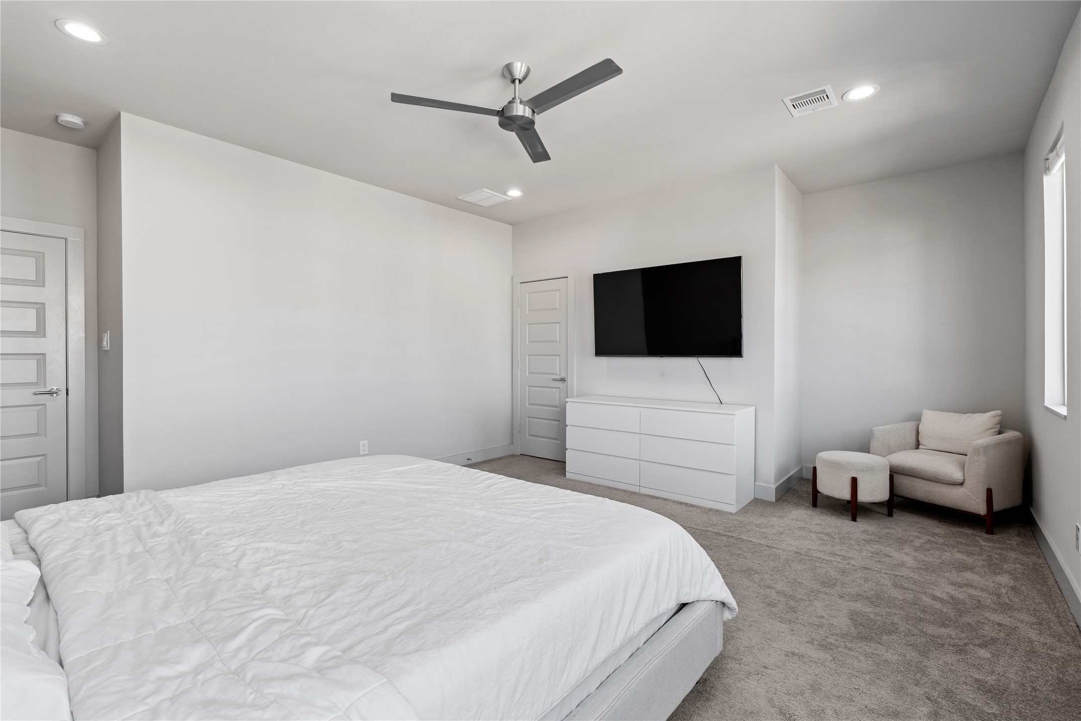 6813 Rocinante Lane Houston, TX 77092 - Photo 17 of 25 a bedroom with a bed a couch and a flat screen tv