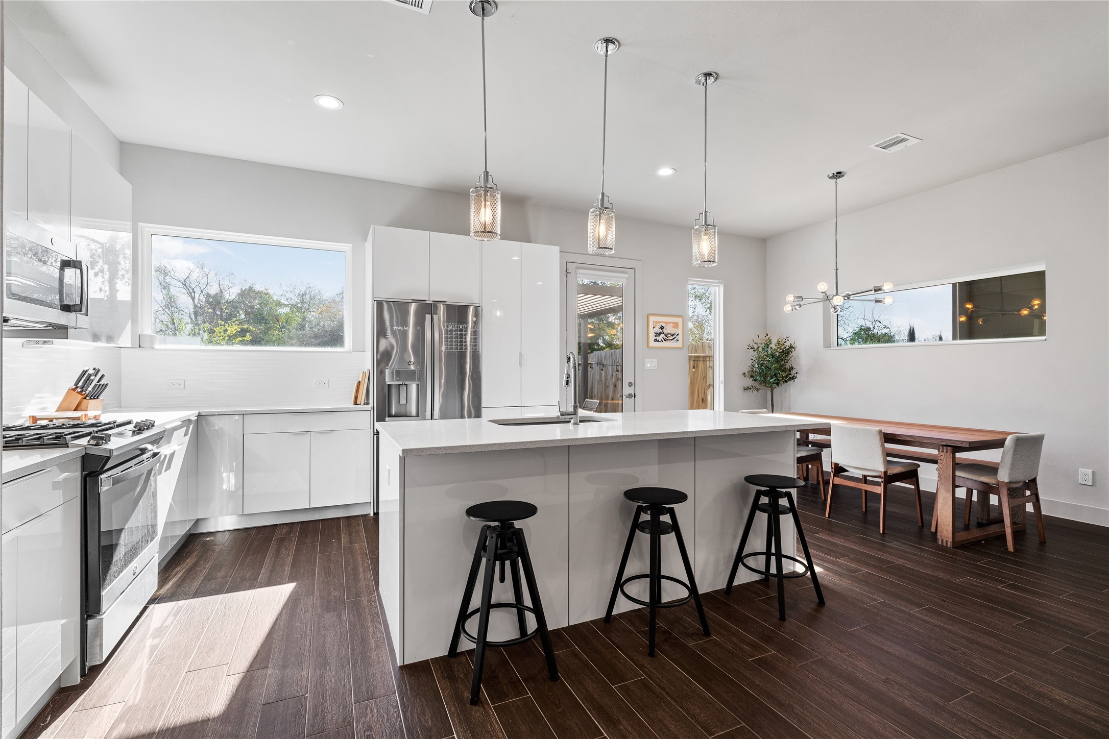 6813 Rocinante Lane Houston, TX 77092 - Photo 8 of 25 a kitchen with stainless steel appliances granite countertop a stove a refrigerator a kitchen island a dining table and chairs with wooden floor