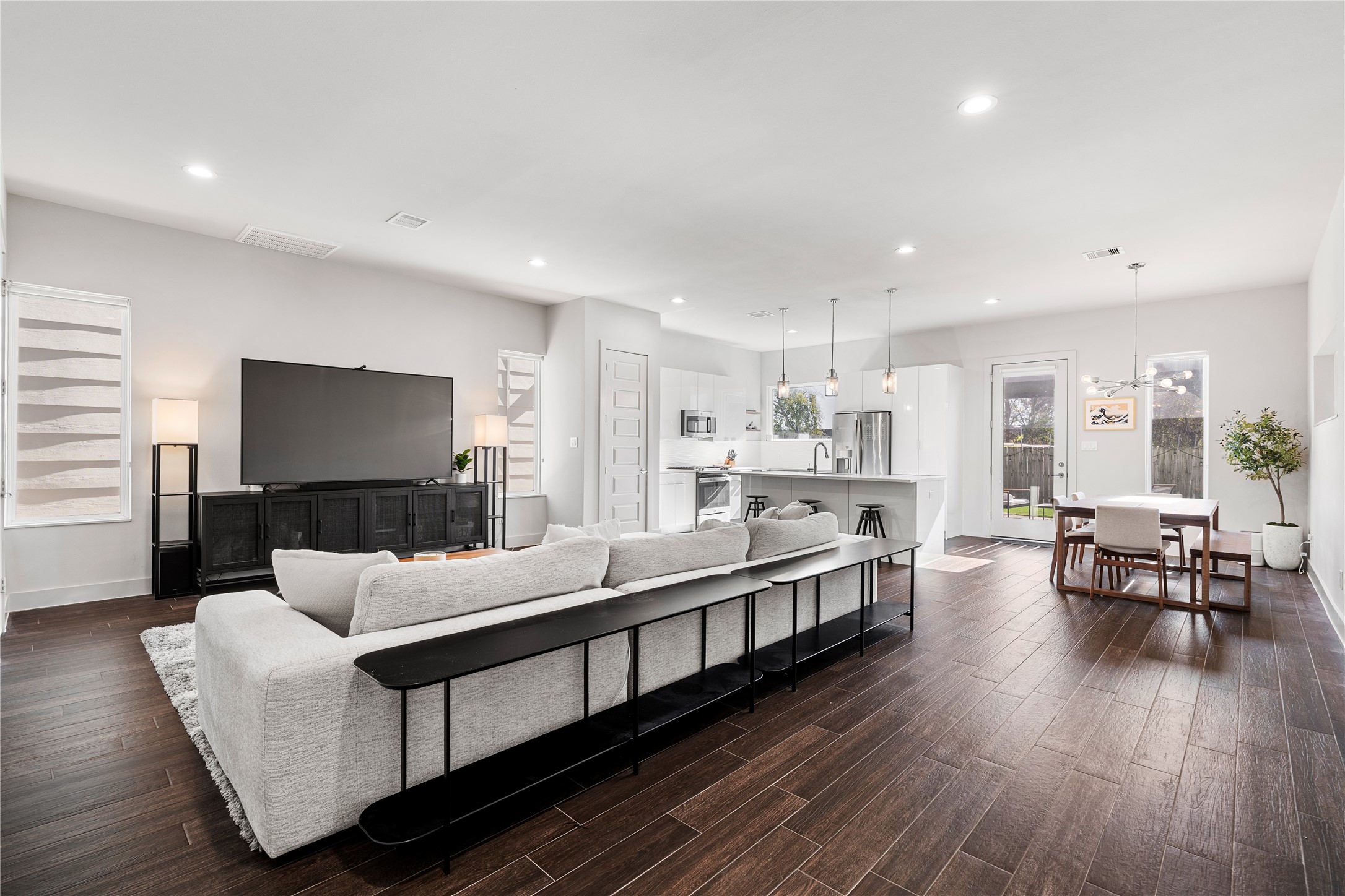 6813 Rocinante Lane Houston, TX 77092 - Photo 10 of 25 a living room with stainless steel appliances kitchen island granite countertop a couch and a wooden floor