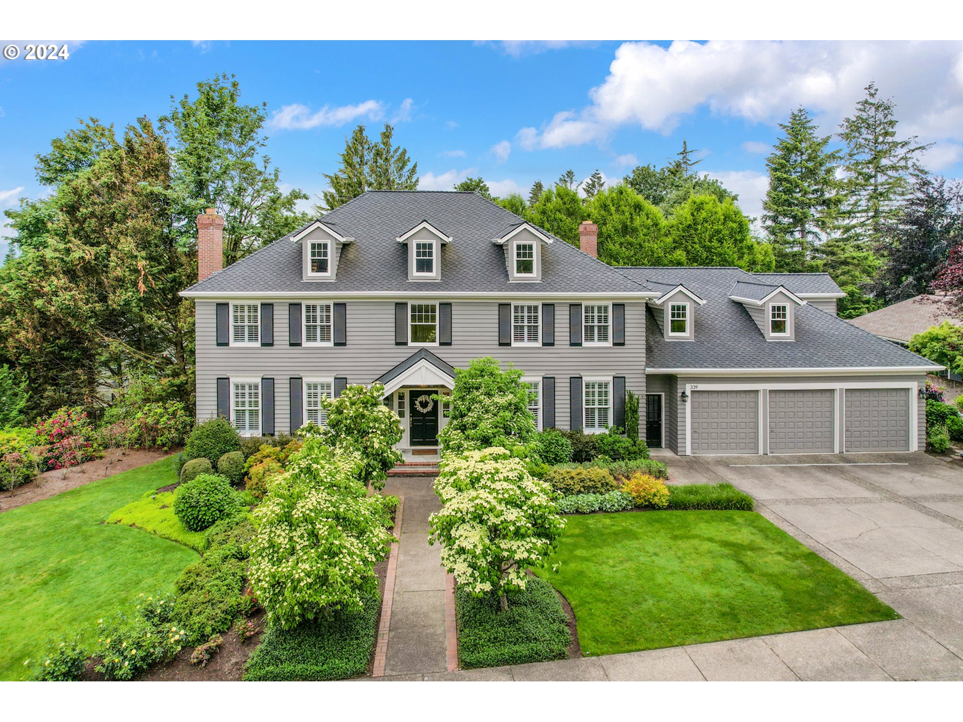 a front view of a house with a garden