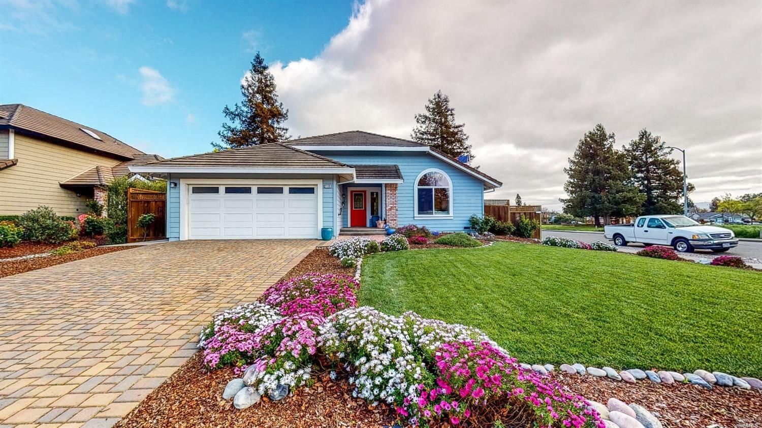 a front view of a house with a yard and garage
