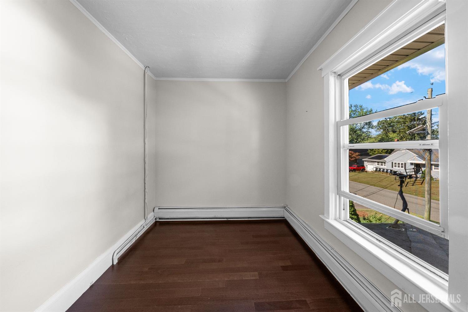 1237 South 10th Street South Plainfield, NJ 07080 - Photo 15 of 23 an empty room with wooden floor and windows