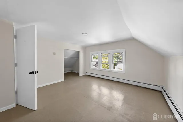 an empty room with windows and closet