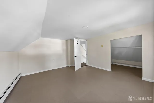 a view of an empty room with a closet