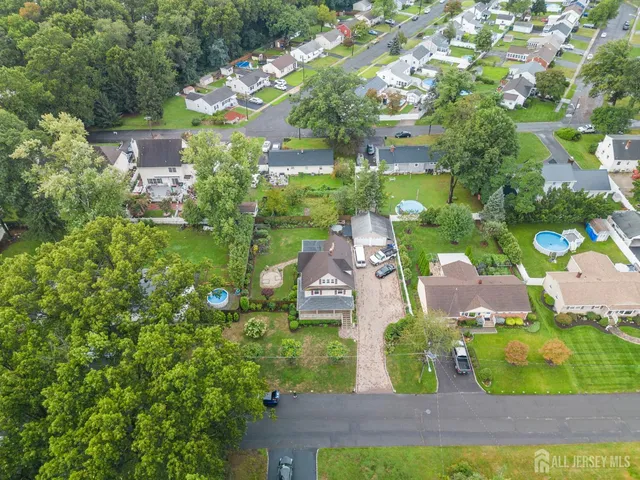 an aerial view of a house with yard swimming pool and outdoor seating
