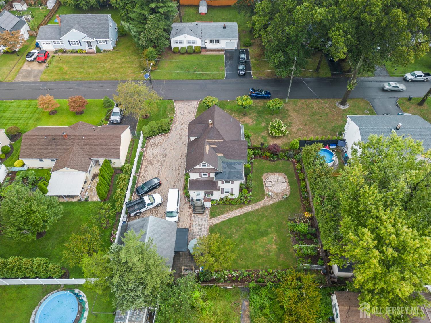 1237 South 10th Street South Plainfield, NJ 07080 - Photo 3 of 23 an aerial view of a house with a garden and swimming pool