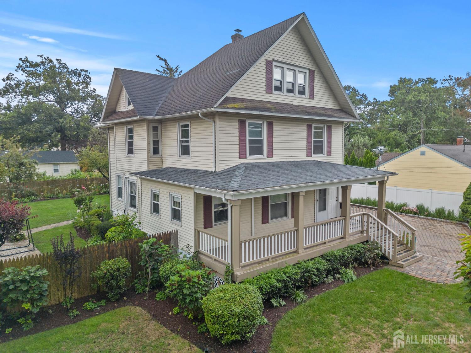 1237 South 10th Street South Plainfield, NJ 07080 - Photo 4 of 23 a view of a white house with a yard and potted plants