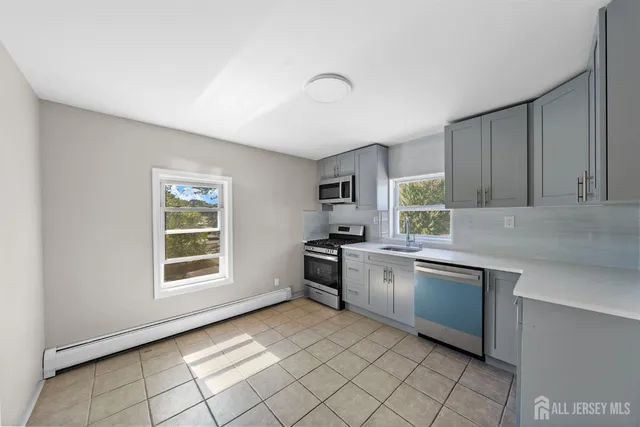 a kitchen with stainless steel appliances granite countertop a stove sink and cabinets