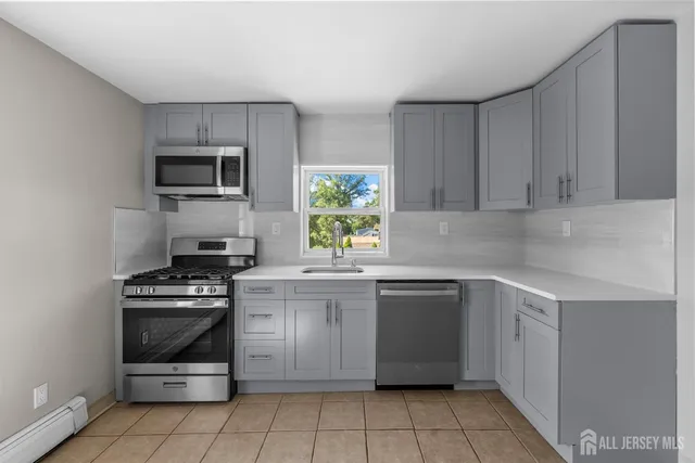 a kitchen with a stove sink and microwave