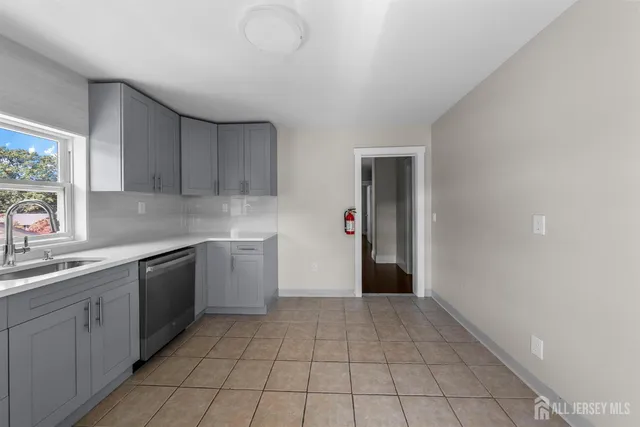 a kitchen with a sink a stove and cabinets