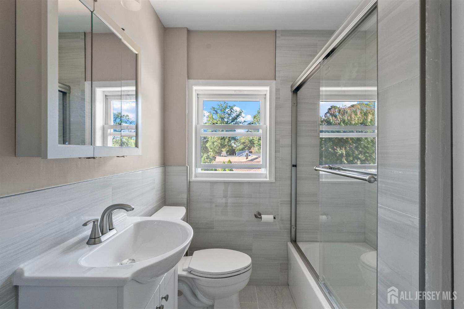 1237 South 10th Street South Plainfield, NJ 07080 - Photo 9 of 23 a bathroom with a sink and a mirror