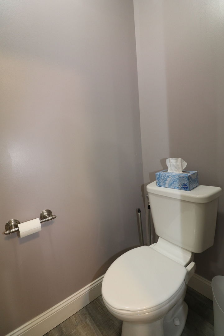 10865 Lake Road Dewitt, IL 61735 - Photo 23 of 35 a white toilet sitting next to a white sink and vanity