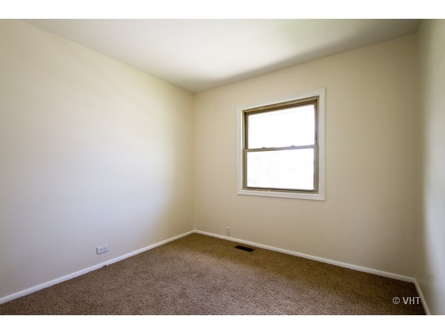627 West Romeo Road Romeoville, IL 60446 - Photo 8 of 10 an empty room with a window