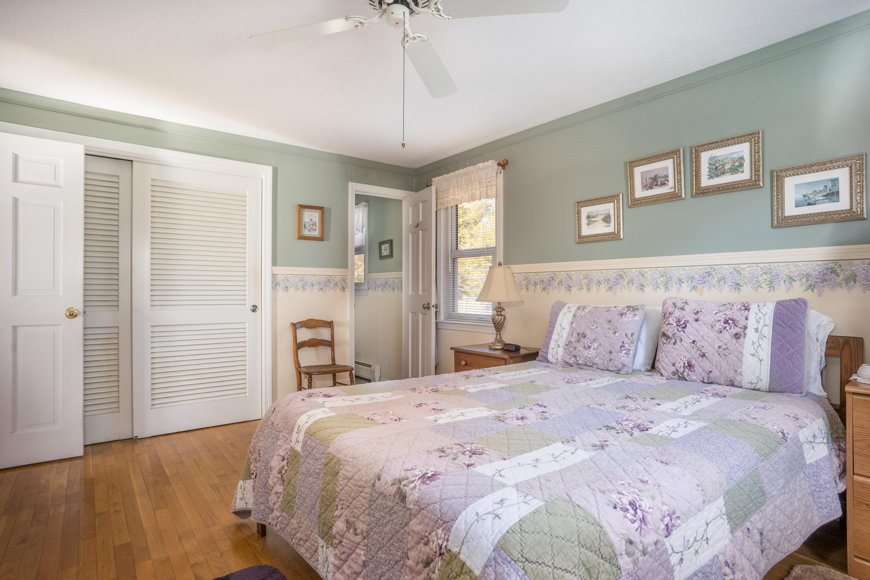 8 Black Valley Road Centerville, MA 02632 - Photo 11 of 15 a bedroom with a large bed and a chandelier