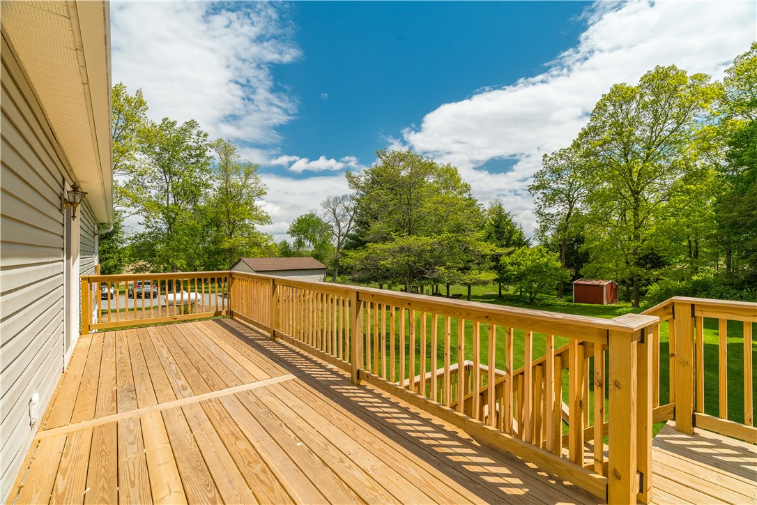 1319 Perry Road Cable, OH 43009 - Photo 35 of 44 This spacious outdoor deck offers a tranquil retreat with views of a lush, expansive yard.