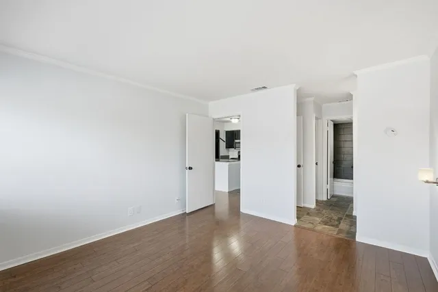 a view of a room with wooden floor