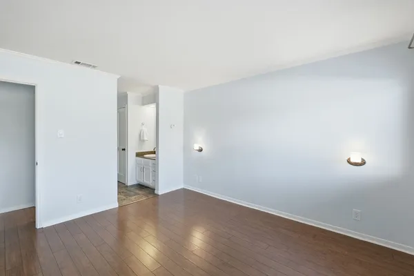a view of a room with wooden floor