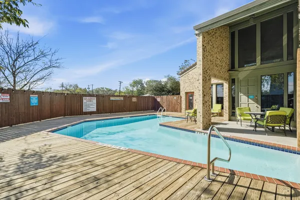a view of a house with backyard and sitting area