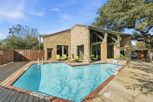 a view of a house with swimming pool and sitting area