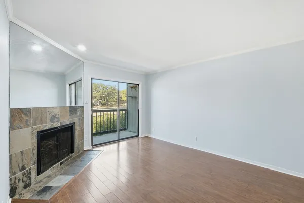 wooden floor in an empty room with a fireplace