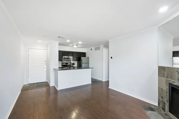 a view of kitchen with stainless steel appliances granite countertop a refrigerator and a stove top oven