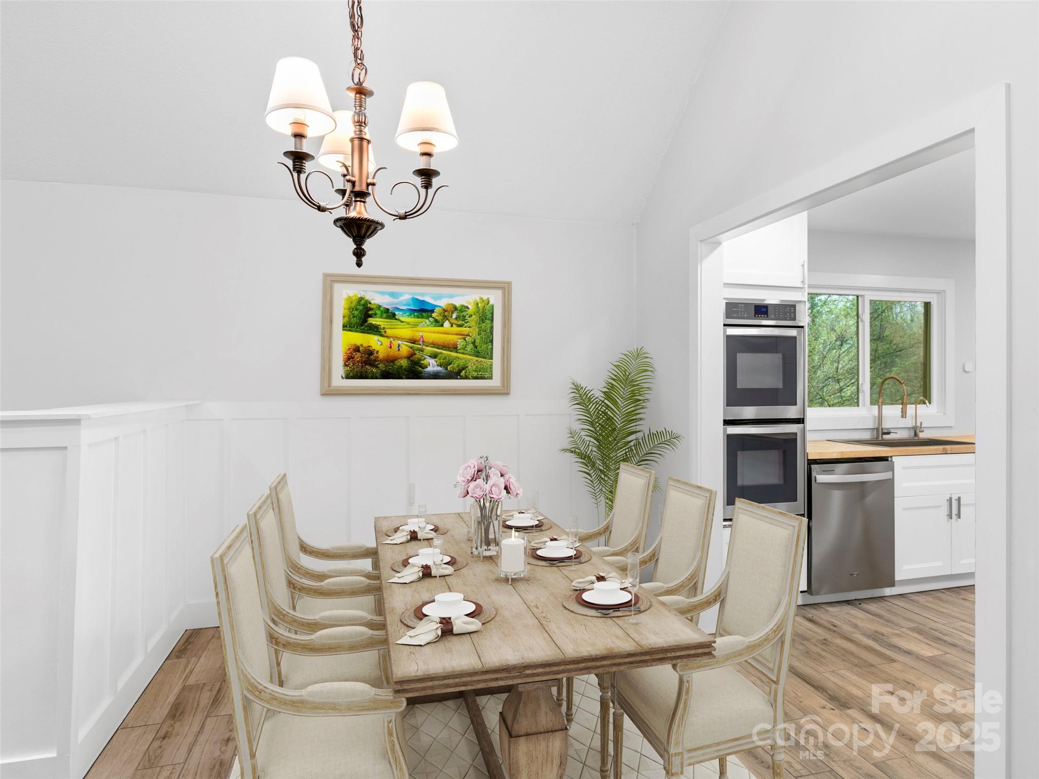 373 Vineyard Road Tryon, NC 28782 - Photo 14 of 46 a view of a dining room with furniture wooden floor and chandelier