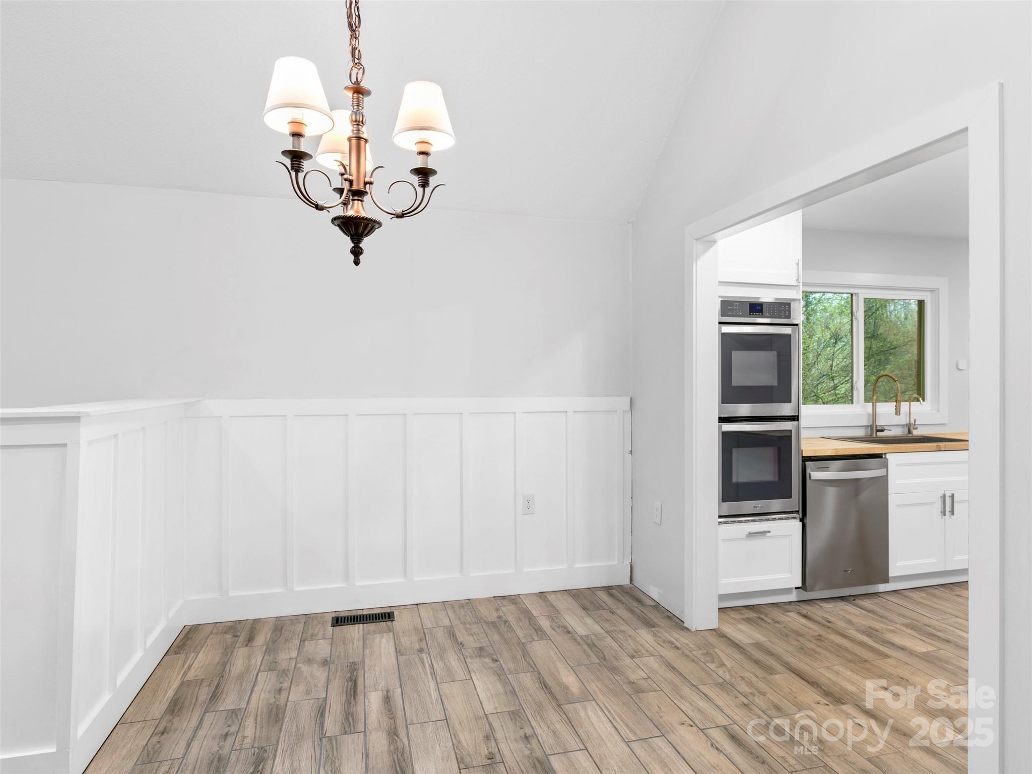 373 Vineyard Road Tryon, NC 28782 - Photo 15 of 46 a view of a kitchen with wooden floor and a sink