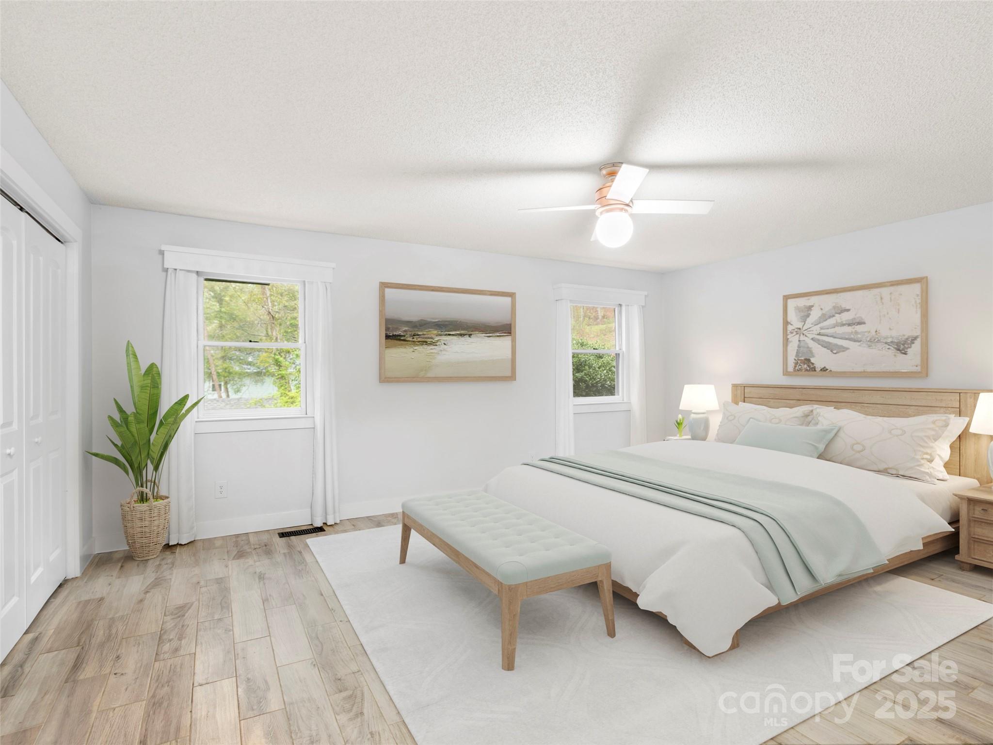 373 Vineyard Road Tryon, NC 28782 - Photo 19 of 46 a bedroom with a large bed and a chandelier