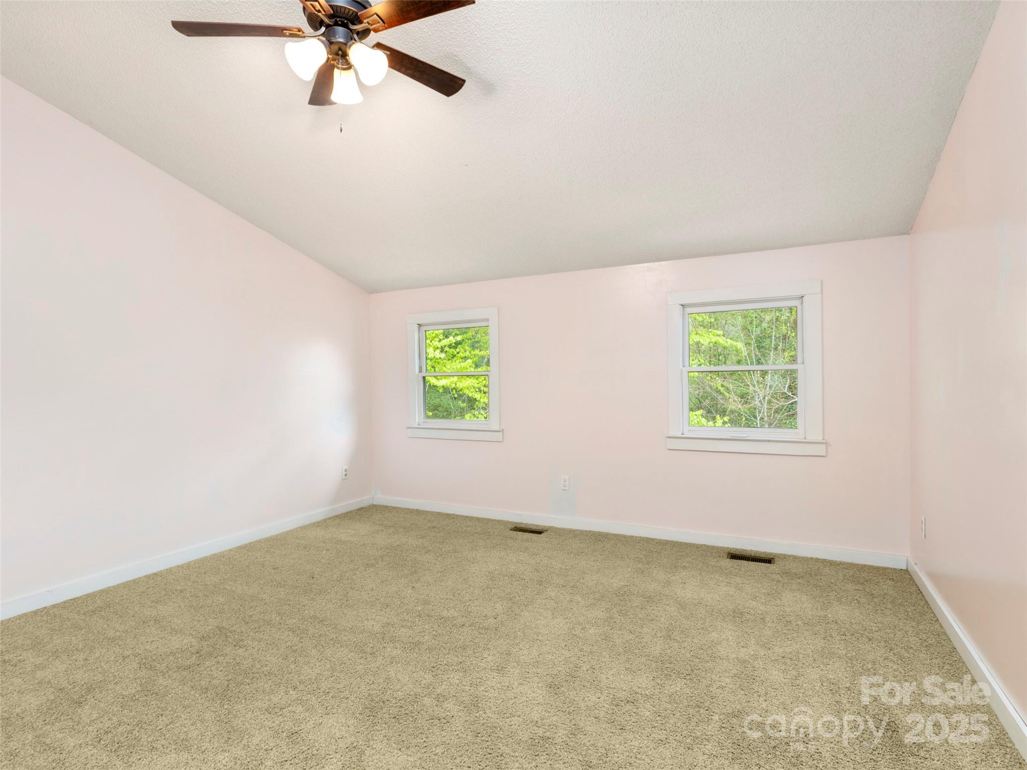 373 Vineyard Road Tryon, NC 28782 - Photo 23 of 46 an empty room with a window and a ceiling fan